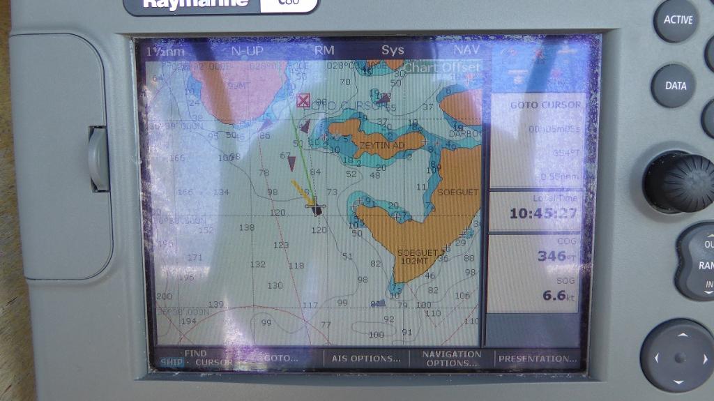 Chartplotter screen. : .   (Sorry about the reflections off the screen) It’s quite old by current standards but does the job for us…….. That’s us centre screen, Green line is our heading, Yellow line is apparent wind direction. 5 other vessels nearby from the AIS (There were 97 AIS equipped vessels in range at that time!) Our speed 6.6Kt, A “Go To” point set 0.5 Nm away at 3540  - Usually used when aiming for a point many miles away.  The yellow bits and little black crosses are non-boat compatible areas.