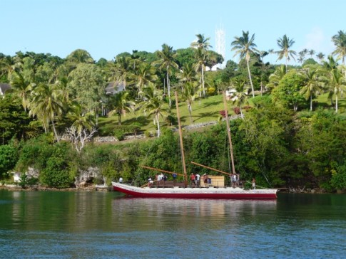 Tongan sailing vessel, royal grounds in background