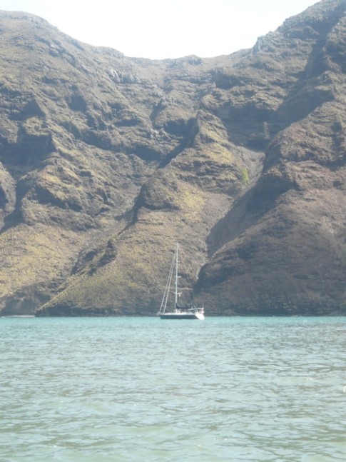 Paikea Mist at anchor against the soaring cliffs of Daniels Bay