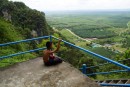 A young boy seemingly contemplates life near the top of the Tiger Cave Temple