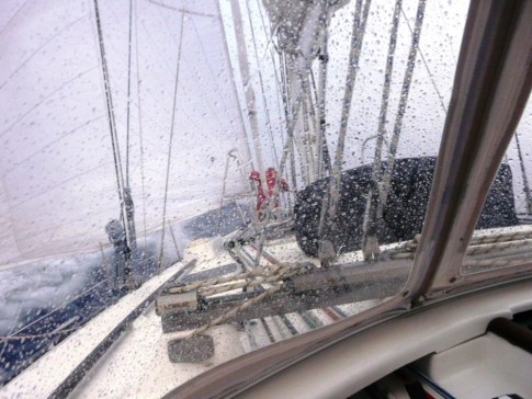 Martin at the mast with the ornery genoa furler in 25 knots of northerly winds and pounding seas