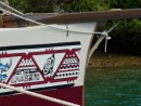 traditional designs grace the bow of the sailing canoe