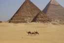Only the camel drivers on the desert behind the pyramids