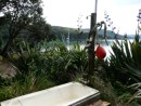 The outdoor bath at Smoke House Bay, Paikea Mist in background