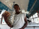 Young man selling food on the bus in Savu Savu