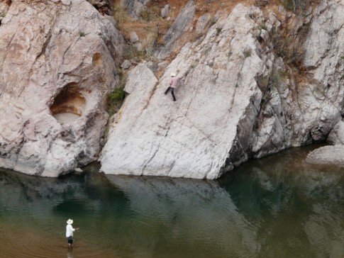 Rurarare men fishing at the riverside- note capable climber on far bank!