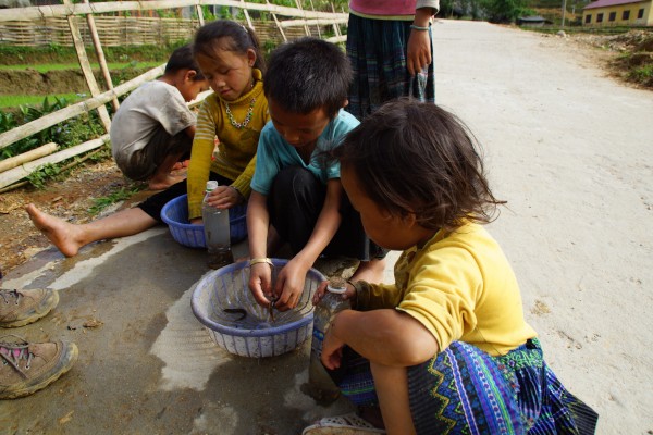 These kids are collecting small eels which they have caught in the rice paddies, yes they are to be eaten!