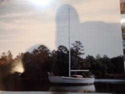 On the Intracoastal Waterway, 1980: We sailed her from New Jersey to Florida with just a single genoa sail.  No sail winches, and only a small winch for hoisting the one anchor.  On the way, Mike installed her oak rubrails.  Note in this picture the rubrails are still natural oak.   The trip took about a month in the middle of Winter, 1300 miles.   It was frigid cold in the Chesapeake and in the Great Dismal Swamp.