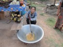 at the roadside "palm sugar area" a lady stirs the pot