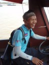 Boeun taeks the helm while the skipper poles us out of harbor