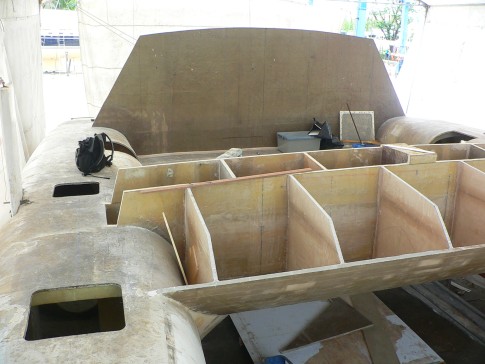 The outline of the cabin has been cut into the bulkhead. the framing for the foredeck and forward bins has been cut. The bins add quite a bit of stiffness and support to the main crossbeam.