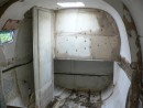 The grey areas on the bulkhead and cabin side are the remains of termite nests, some of which can be seen on the floor.