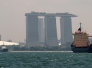 Dock space is at a premium in Singapore. This ship has found an innovative solution.