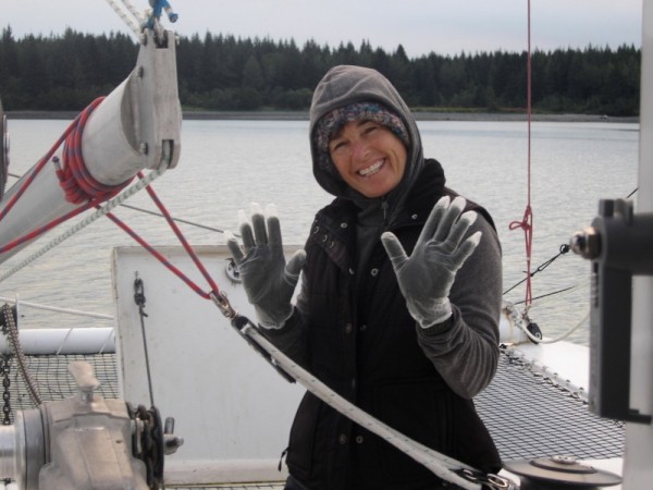 Annette finds a way to keep her hands warm and dry while pulling anchor.