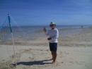 Party on the sand bar - Tom setting up a volleyball net
