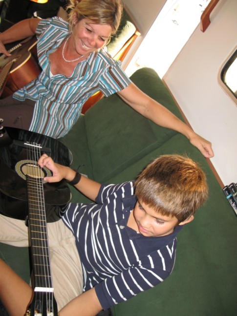Isabele from s/v Wasabi gives a guitar lesson to Cole in Panama City