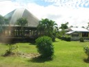 Open fale and surrounding huts in a local village in Upolu, Samoa