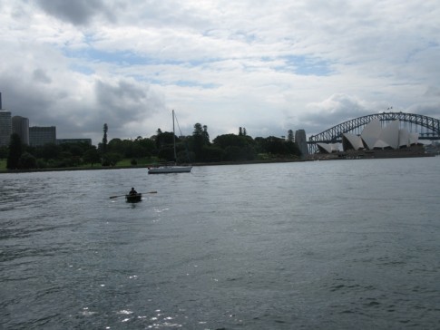 Cole rowing back to "Blackjack" while she was anchored for the evening next to Opera House and Botanical Gardens