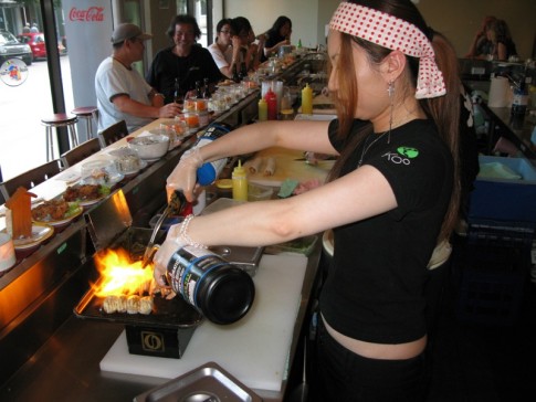 Head chef at Sushi Train cooking up some salmon and scallops