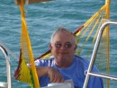 Grandpa relxes in the hammock aboard s/v Azure Pleasure