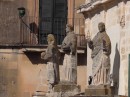 Three scholastic-looking gentlemen in a corner of the Duomo.