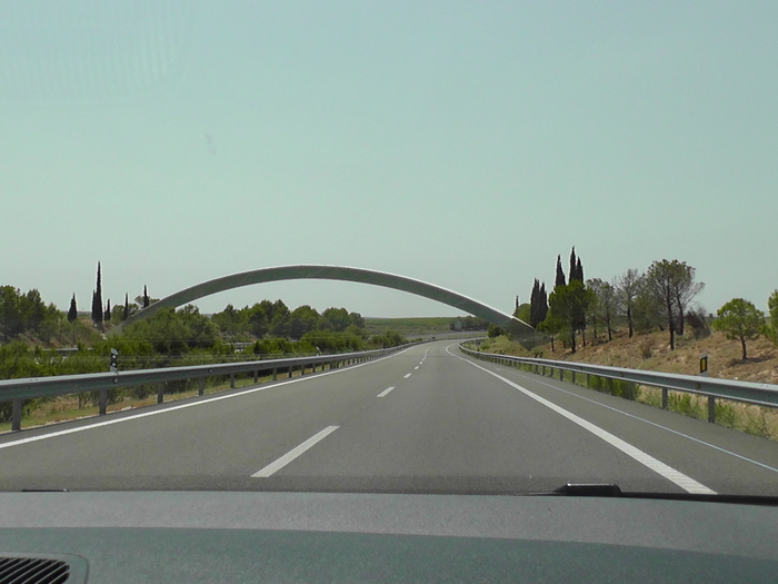 Road to Pamplona: Prime Meridian crosses road at large metal arch
