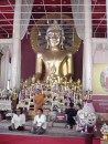 Wat Phra Singh: This image of Buddha is revered above others in Chiang Mai and is often removed and paraded around the city.  Purple and white column cap at lower right is entirely made of intricately woven flowers.