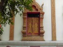 Wat Chiang Man: Carved window shutters.