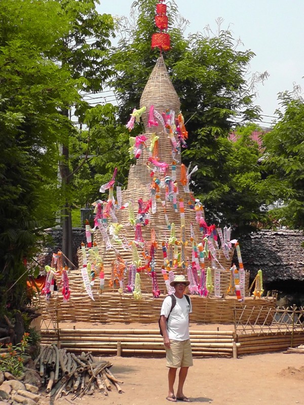 This a tiered hill of sand built for prayers and wishes for the New Year hanging from sticks stuck in the sand.