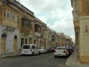 Typical Maltese street and architecture -lots of garden windows.