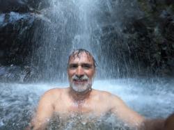 Greg in the waterfall on Raiatea