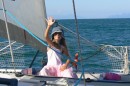 Zoe making a sailboat out of her dinghy on the foredeck as we sail