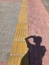 “Me And My Shadow”. Taking a photo of the mysterious yellow lane on the sidewalks of Centrum in Alanya.