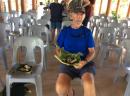 SAMOA: Eric esting lunch on frond plate that he wove.  Food cooked on open cloves.