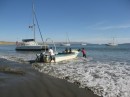 Launching a panga, aground "Island Girl" in the background