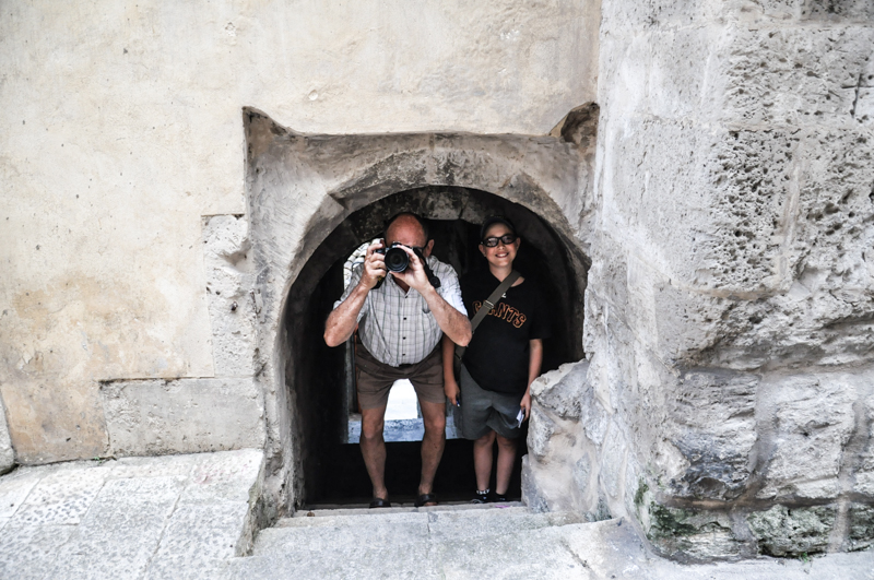 Little Doorways: Reg and Dante in small tunnel leading down to another street