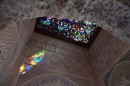 Stained glass roof window with sun peeking through