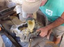 A mixture made of concrete is poured into the mold.  He then clamps it and applies pressure by hand!!!
