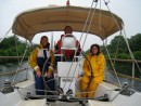 Chris, Paul and Heather take shelter from light rain under the bimini in the Caledonian canal as we get underway going into Loch Ness. they are all smiles because this is the first day of rain.  