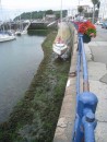 Victoria Marina St. Peter Port Guernsey. Boat is tied along the wharf to dry out at low tide