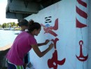 mariska and rochelle painting the mural at the marina