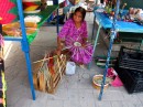 Indian woman weaving baskets for sale