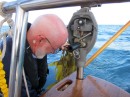 Bob takes kelp off the windvane