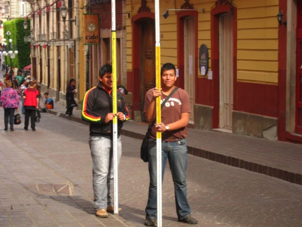 Two university students learning to survey on the street outside our hotel