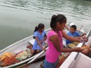 This picture was taken near Texan Bay. The children paddled out in their cayugas with interesting things to buy.