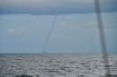 As more and more waterspouts kept forming, we finally decided to turn around and head for a protected anchorage. 