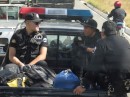 Guatemalan police officers riding shotgun.