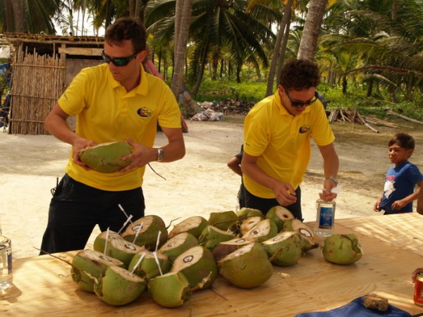 ARC staff filling coconuts with rum for the REndezvous