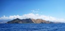 Part of the coast of Flores. From the sea These Indonesian Islands are spectacular. From rugged and barren like this, to dense rainforest right to the water