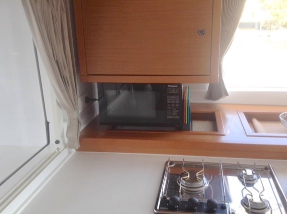 950 watt Microwave suspended from bellow cupboard via 2 x AL angle brackets.